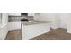 Well-designed kitchen showcasing granite countertops, stainless steel appliances, white cabinets, and wood-look floors at 108 Pisgah St, Sanford, NC 27330