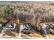 An aerial view of a modern home surrounded by beautiful forest and other Gathering homes at 110 Black Swan Dr, Youngsville, NC 27596