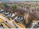 An aerial view of a modern home surrounded by beautiful forest and other Gathering homes at 110 Black Swan Dr, Youngsville, NC 27596
