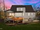 Backyard view of a beautiful home with a large elevated deck and screened in porch at 110 Black Swan Dr, Youngsville, NC 27596