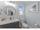 Well-lit bathroom featuring a modern vanity, toilet, and stylish mirror at 110 Black Swan Dr, Youngsville, NC 27596