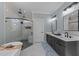 Bright bathroom featuring a modern tub, glass enclosed shower, and double vanity sinks at 110 Black Swan Dr, Youngsville, NC 27596