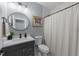 Well-lit bathroom featuring a modern vanity, round mirror, and a framed print on the wall at 110 Black Swan Dr, Youngsville, NC 27596