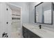 Beautiful bathroom featuring a modern vanity, a framed mirror, and an open shower with tiled walls at 110 Black Swan Dr, Youngsville, NC 27596