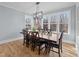 Bright dining room features a wood table, matching chairs, wood floors, and large windows with outdoor views at 110 Black Swan Dr, Youngsville, NC 27596