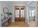 Entryway with wood floors, a console table with decor, and a view to an office at 110 Black Swan Dr, Youngsville, NC 27596