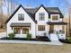 Stunning new construction farmhouse with modern black accents, manicured landscaping, and inviting front porch at 110 Black Swan Dr, Youngsville, NC 27596