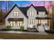 Elegant farmhouse-style home featuring striking black trim, professionally landscaped front yard, and cozy front porch at 110 Black Swan Dr, Youngsville, NC 27596