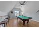 Spacious game room with a pool table, wood floors, vaulted ceilings and custom bar with seating at 110 Black Swan Dr, Youngsville, NC 27596