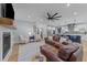 Open-concept living room features hardwood floors, comfortable seating, and seamless flow to the kitchen at 110 Black Swan Dr, Youngsville, NC 27596