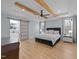 Main bedroom boasts wood floors, tray ceilings with beams, and a barn door to the ensuite bath at 110 Black Swan Dr, Youngsville, NC 27596