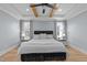 Main bedroom boasts wood floors, tray ceilings with beams, and a soft neutral color palette at 110 Black Swan Dr, Youngsville, NC 27596