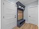Mud room features a built-in bench and storage unit with coat hooks, and neutral paint scheme at 110 Black Swan Dr, Youngsville, NC 27596