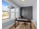 Office space with a large window and a dark accent wall with geometric design at 110 Black Swan Dr, Youngsville, NC 27596