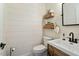 Modern half-bathroom with shiplap walls, rustic vanity, and stylish fixtures at 1104 Garnet Ridge Way, Raleigh, NC 27607