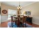Cozy dining room featuring hardwood floors, a round table, and ample natural light at 1104 Garnet Ridge Way, Raleigh, NC 27607
