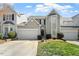Charming townhouse featuring a garage, manicured lawn, and well-maintained landscaping at 1104 Garnet Ridge Way, Raleigh, NC 27607