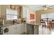 Bright kitchen with white cabinets, granite countertops, and a stainless steel dishwasher at 1104 Garnet Ridge Way, Raleigh, NC 27607