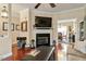Cozy living room with a fireplace, TV, hardwood floors, and comfortable seating at 1104 Garnet Ridge Way, Raleigh, NC 27607