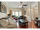 Spacious living room with hardwood floors, large windows, and comfortable seating arrangements at 1104 Garnet Ridge Way, Raleigh, NC 27607