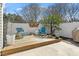 Charming patio with wooden deck, seating, lush greenery, privacy fence, and outdoor dining area at 1104 Garnet Ridge Way, Raleigh, NC 27607