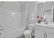 Clean, white bathroom with tub and shower combination, a vanity with sink, and light gray flooring at 1131 Pate Farm Ln, Durham, NC 27703