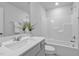 Clean, white bathroom with tub and shower combination and a vanity with sink at 1131 Pate Farm Ln, Durham, NC 27703