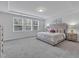 Bright bedroom featuring neutral decor, a large window, and plush carpeting at 1131 Pate Farm Ln, Durham, NC 27703