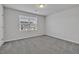 Empty bedroom with carpeted flooring, one large window, and neutral walls at 1131 Pate Farm Ln, Durham, NC 27703