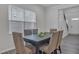 Dining room with a dark wood table, six upholstered chairs, and a large window with blinds at 1131 Pate Farm Ln, Durham, NC 27703