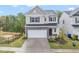 Charming two-story home with stone accents, a two-car garage, and a well-manicured lawn at 1131 Pate Farm Ln, Durham, NC 27703