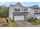 Charming two-story home featuring a stone facade, attached two-car garage, and well-manicured landscaping at 1131 Pate Farm Ln, Durham, NC 27703