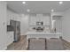 Modern kitchen featuring white cabinets, stainless steel appliances, and a spacious island at 1131 Pate Farm Ln, Durham, NC 27703