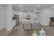 Bright kitchen featuring stainless steel appliances, white cabinets, and a center island with bar seating at 1131 Pate Farm Ln, Durham, NC 27703