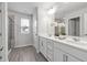 Bright main bathroom with double vanity, white cabinets, and a glass-enclosed shower at 1131 Pate Farm Ln, Durham, NC 27703