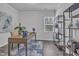 Bright home office featuring a wooden desk, shelving, and a view from the window at 1131 Pate Farm Ln, Durham, NC 27703