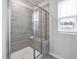 Modern shower featuring neutral tile, a built-in bench, and a glass enclosure at 1131 Pate Farm Ln, Durham, NC 27703