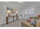 Upstairs sitting area with leather chairs, carpeted flooring, and an accent table with lamps at 1131 Pate Farm Ln, Durham, NC 27703