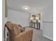 Carpeted sitting area with leather chairs, an accent table with lamps, and neutral paint at 1131 Pate Farm Ln, Durham, NC 27703