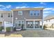 Gray home showing back patio, bright windows, and lawn with green shrubbery at 1160 Craigmeade Dr, Morrisville, NC 27560
