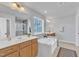 Spacious bathroom featuring double vanity sinks, a soaking tub, and a separate glass enclosed shower at 1160 Craigmeade Dr, Morrisville, NC 27560