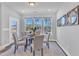Bright dining area with a glass-top table, upholstered chairs, and large windows offering a pleasant view at 1160 Craigmeade Dr, Morrisville, NC 27560