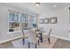 Cozy dining area featuring a glass-top table with comfortable chairs and large windows at 1160 Craigmeade Dr, Morrisville, NC 27560