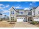 Charming townhome showcasing stone accents, neutral siding, and an attached two-car garage at 1160 Craigmeade Dr, Morrisville, NC 27560