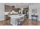 Well-equipped kitchen featuring dark cabinetry, stainless steel appliances, and a central island with barstool seating at 1160 Craigmeade Dr, Morrisville, NC 27560