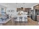 Modern kitchen with stainless steel appliances, a central island with seating, and a dining area at 1160 Craigmeade Dr, Morrisville, NC 27560