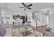 Open-concept living space featuring hardwood floors, a ceiling fan, and a staircase to the second floor at 1160 Craigmeade Dr, Morrisville, NC 27560