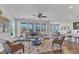 Bright living room featuring hardwood floors, a ceiling fan, and large windows offering natural light at 1160 Craigmeade Dr, Morrisville, NC 27560