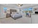 Airy main bedroom with large windows, tray ceiling, and upholstered headboard at 1160 Craigmeade Dr, Morrisville, NC 27560