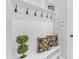 Bright mudroom area with coat hooks, shelving, and cushioned seating at 1160 Craigmeade Dr, Morrisville, NC 27560